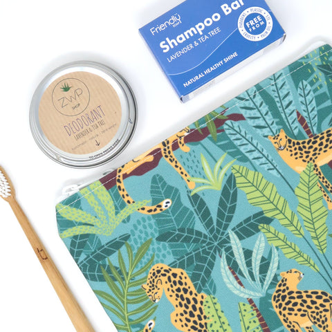 green leopard print zip bag with eco friendly toothbrush, deodorant and shampoo bar