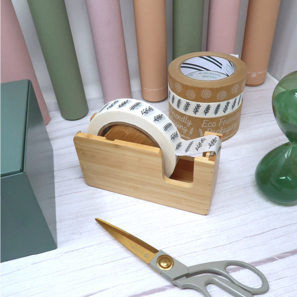 bamboo tape dispenser and tapes sitting on a table top