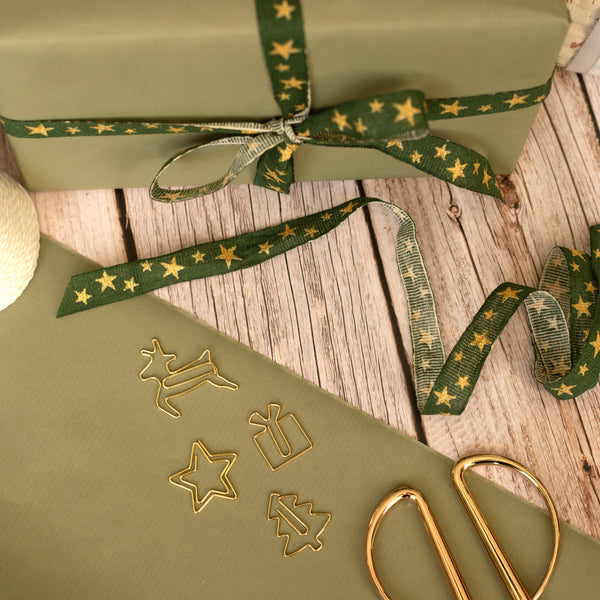 Festive Paper clips with green wrapped gifts and gold scissors