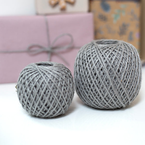 2 balls of twine in front of wrapped presents