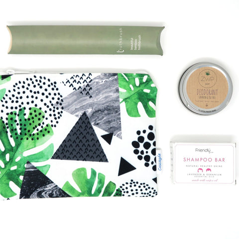 leaf pattern zip bag with eco friednly bamboo toothbrush, deodorant and shampoo bar