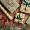 Gift boxes wrapped in festive paper with ribbons on a wooden surface.
