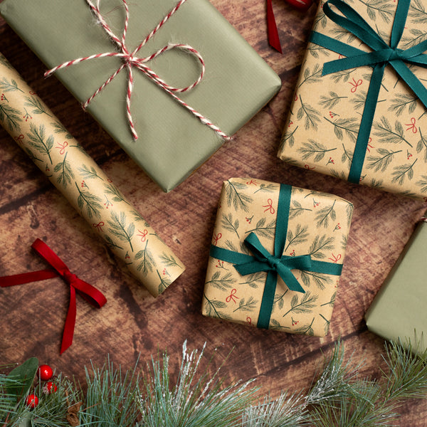 Gift boxes wrapped in festive paper with ribbons on a wooden surface.