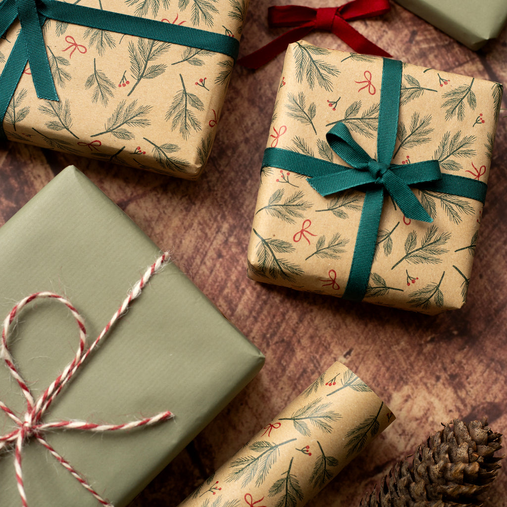 Gift boxes wrapped in festive paper with ribbons on a wooden surface.