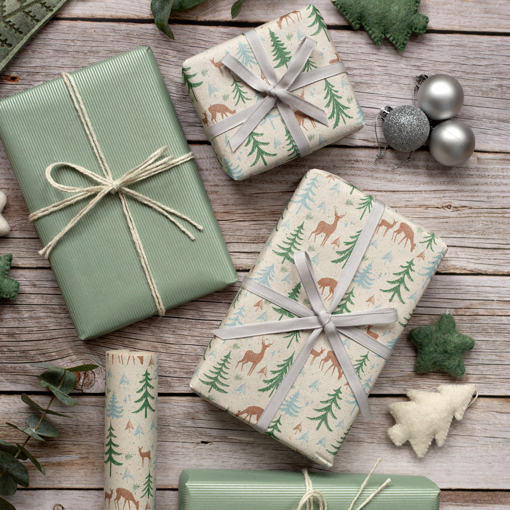 Gift boxes wrapped in festive paper with ribbons on a wooden surface.