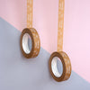 Two rolls of brown tape with 'Happy Birthday' text on a pink and gray background