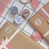 Two wrapped gifts with ribbons on a checkered surface