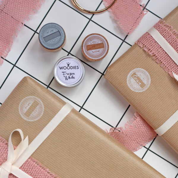 Two wrapped gifts with ribbons on a checkered surface