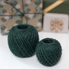 2 balls of twine in front of wrapped presents