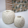 2 balls of twine in front of a wrapped present
