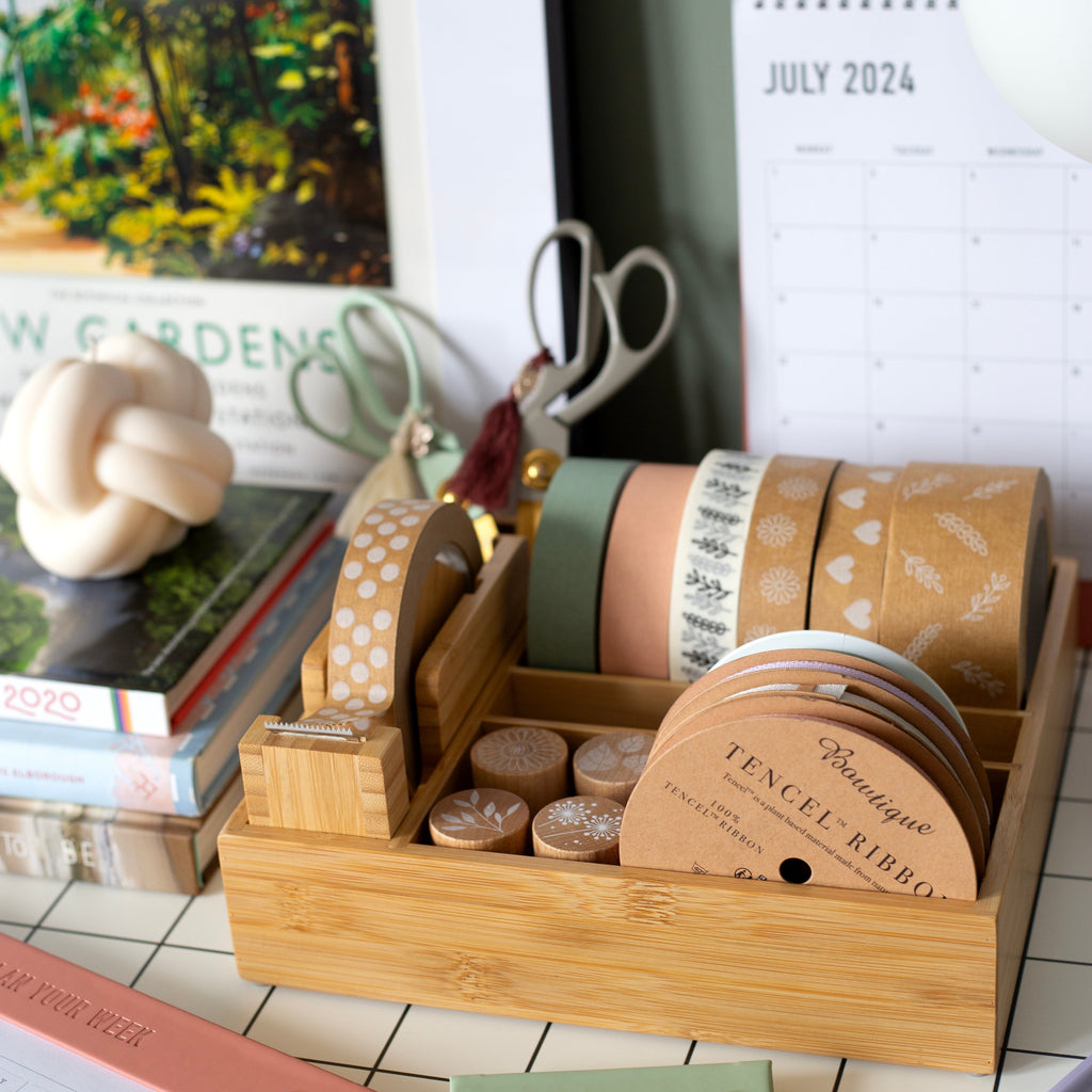 bamboo desk organiser stocked with ribbon, tapes and stamps