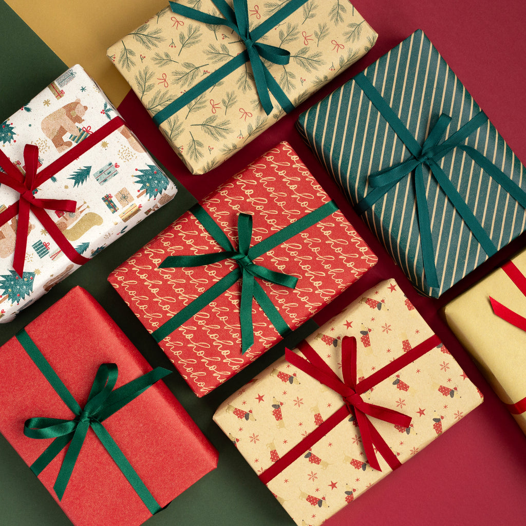 Assorted Christmas gift boxes with ribbons on a red background