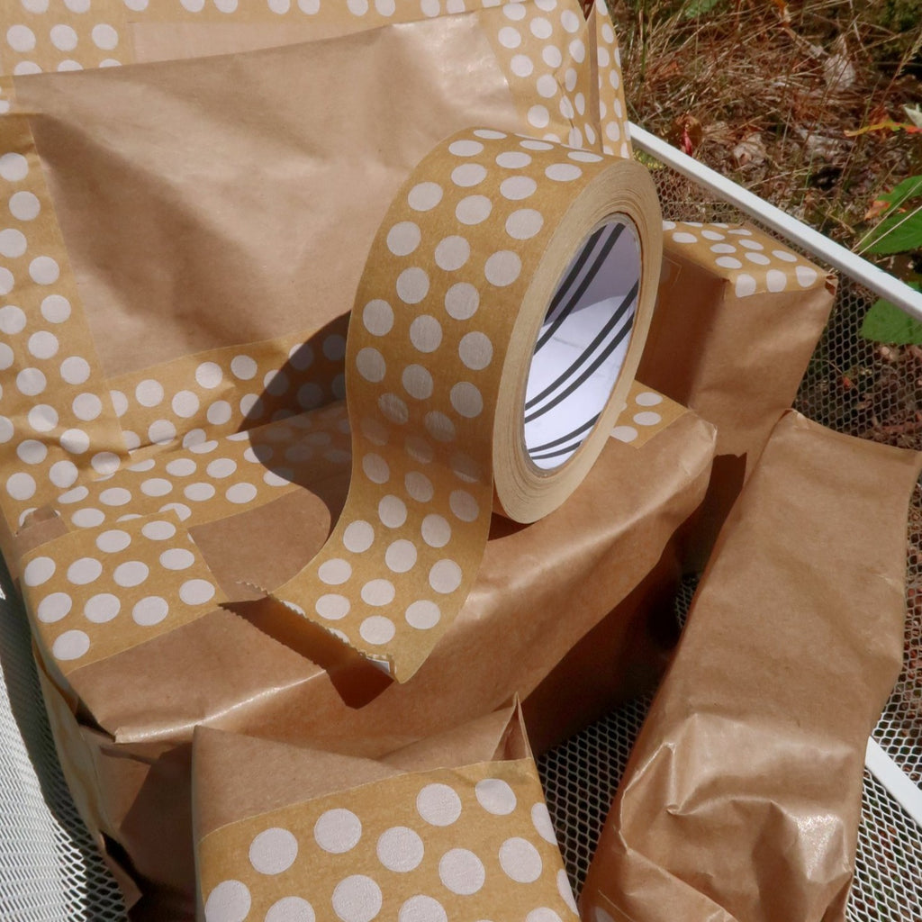 brown packages sealed with white dot patterned paper tape