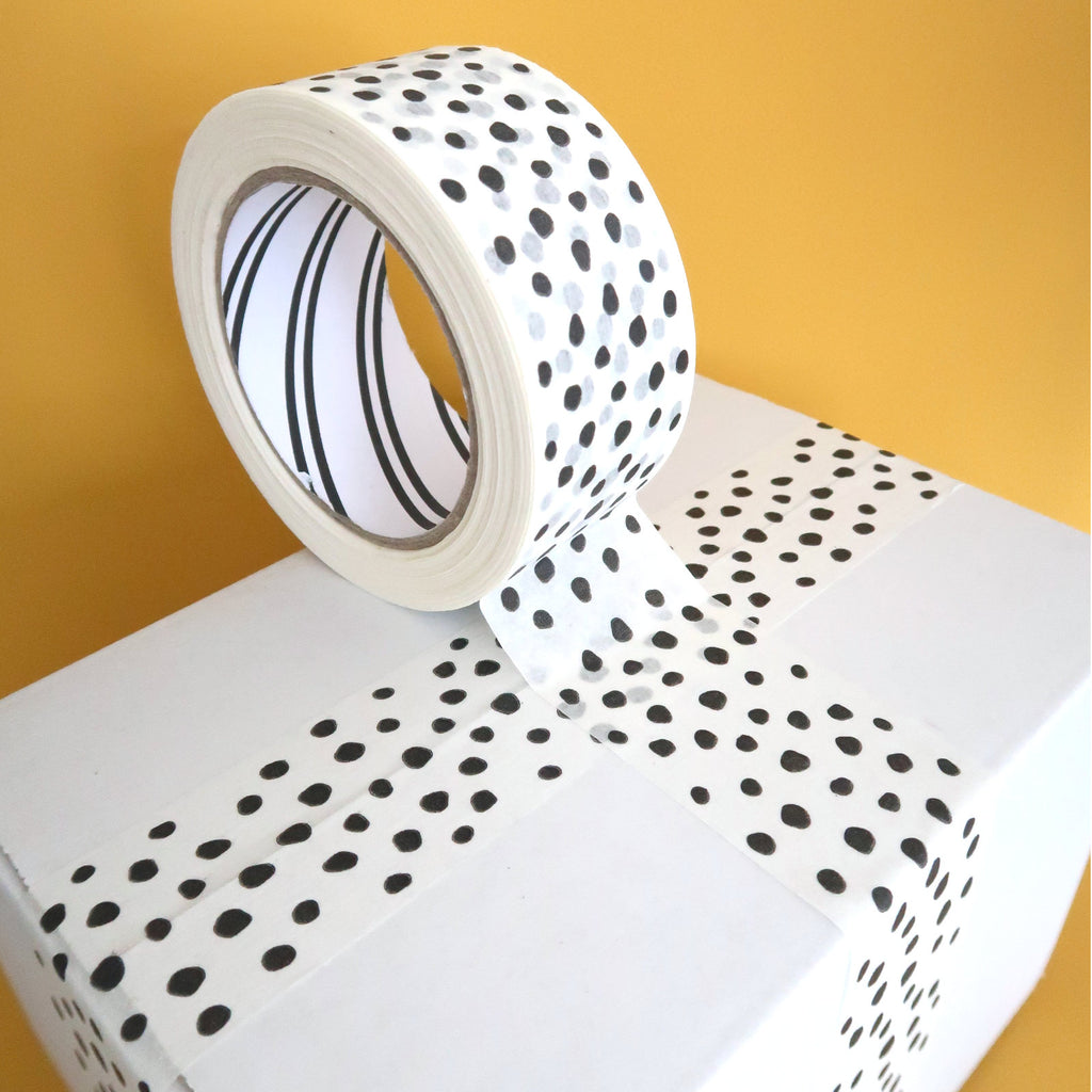 White paper tape with black dots on white boxes with a yellow background