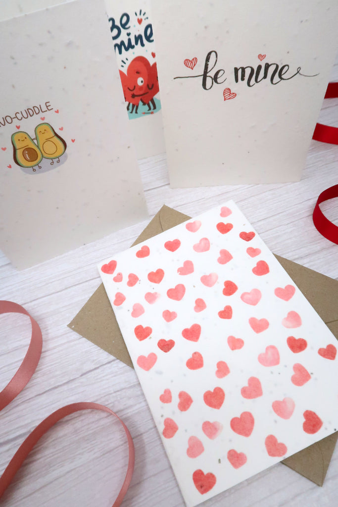 valentines cards with love hear patterns surrounded by red ribbons