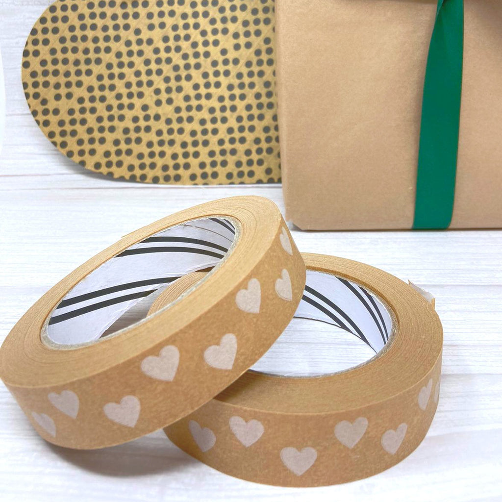 heart paper tape with presents wrapped in green ribbon with a big polka dot gift heart in the background
