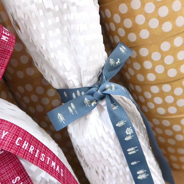 bottle wrapped in white honeycomb protective wrap with white dots tape in the background
